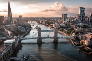 The iconic landmark Tower Bridge illuminated at night in London, which crosses the River Thames allowing vehicles to cross the river, but also raise the drawbridge and allow large ships to sail through.