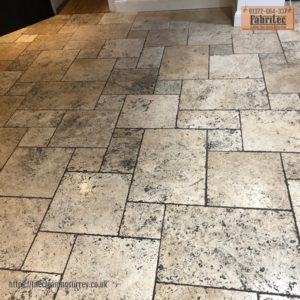 image of a soiled and damaged travertine floor before restoration by Fabritec Tile Cleaning